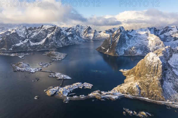 View of islands, fjord and mountains, snow-covered landscapeFishing villages Hamnøy, Sakrisøy and