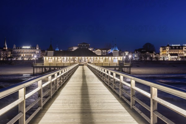 Restaurant on Ahlbeck Pier, Seebrücke Ahlbeck illuminated at dusk in the Baltic Sea on Usedom