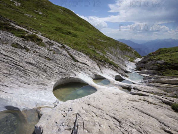 Glacier mill with glacier pots on the Trinser Alp Mora, Trin, Canton Graubünden, Switzerland,