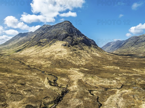 Buachaille Etive Beag and Three Sisters in Glencoe over Moors and Road A82 from a drone, Highlands,