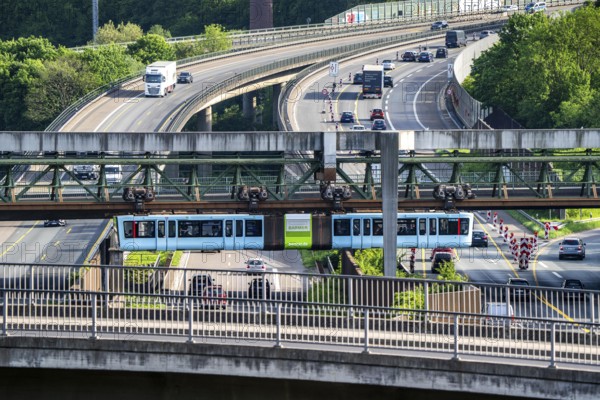 The Wuppertal suspension railway, train of the latest generation 15, crosses the A46 motorway,