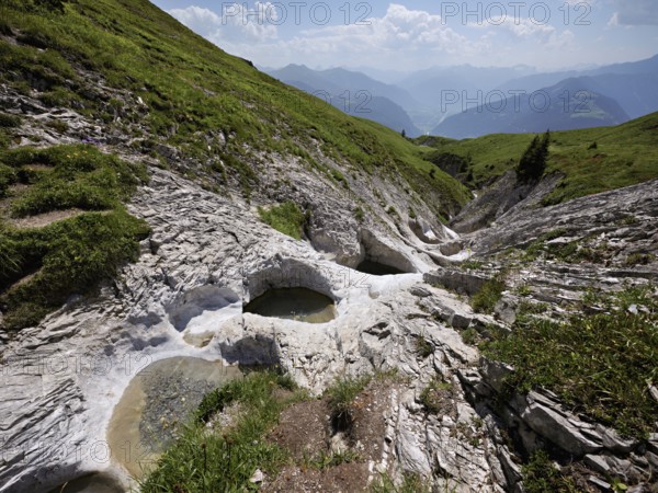 Glacier mill with glacier pots on the Trinser Alp Mora, Trin, Canton Graubünden, Switzerland,