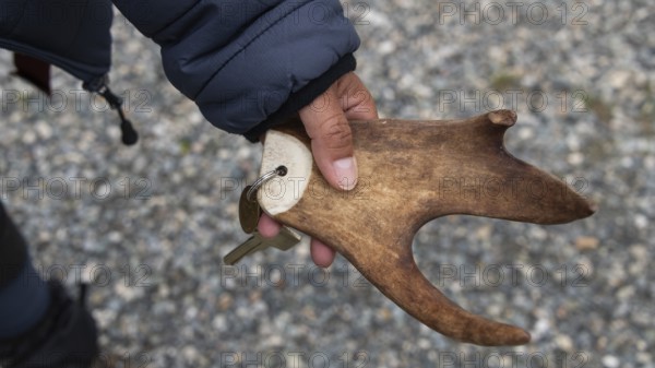 Part of a reindeer antler, hand holding key ring, Kongsvoll or Kongsvold Fjeldstue, historic