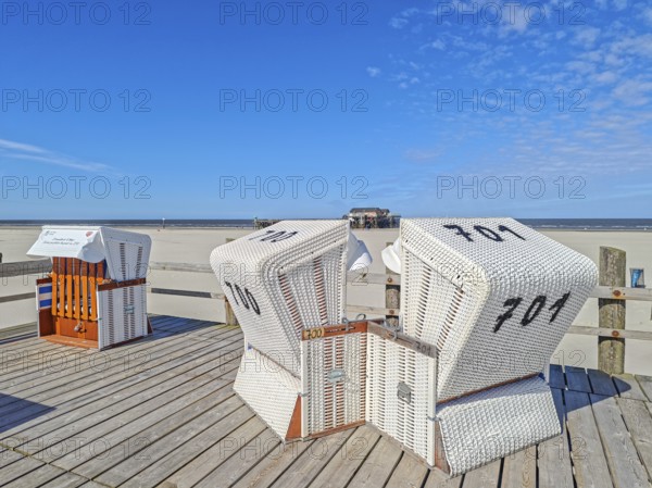 Preparing for the high season on the beach, setting up the beach chairs, North Sea, on the edge of