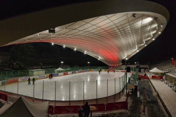 Tourists on ice rink, ice sports stadium, ice skating in the evening, Schierker Feuerstein Arena,