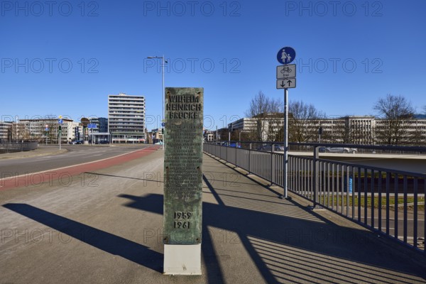 Footpath and cycle path, metal railing, lantern, general architecture, high-rise building, stele
