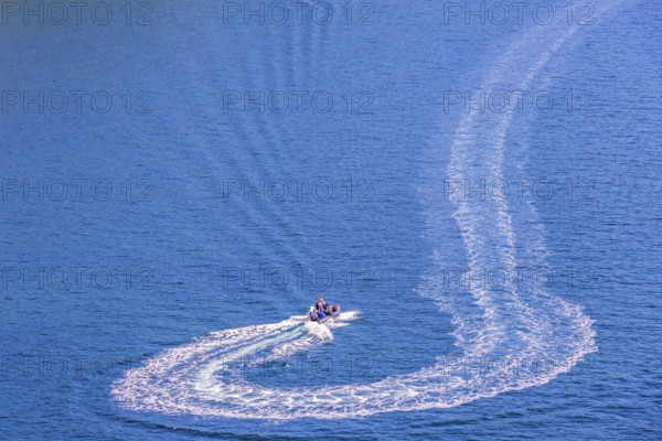 Motorboat that has made a turn on the sea with white wake pattern, Crozon peninsula, Bretagne,