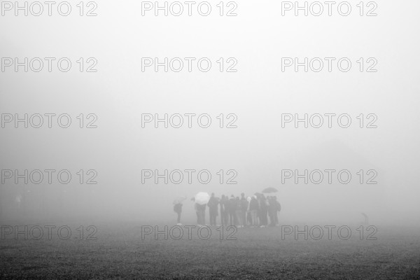 Group of visitors in the fog at beech forest concentration camp, today a concentration camp