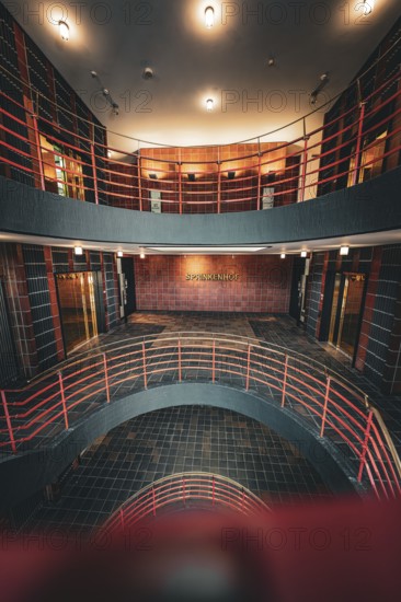 Modern multi-storey staircase with industrial flair and warm lighting, SPRINKENHOF, Hamburg,