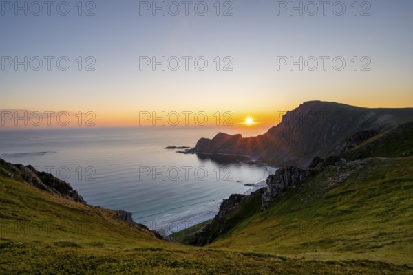 View of coastal landscape at sunset, cliffs and summit of Måtind or Måtinden, Høyvika beach and