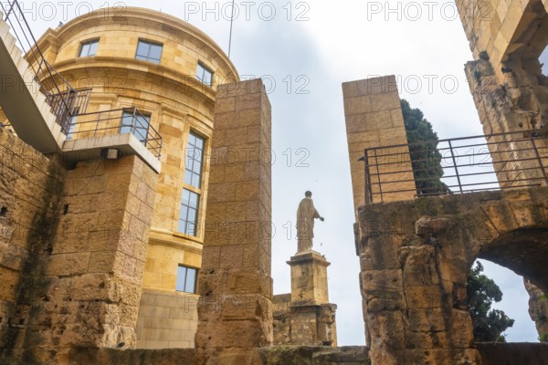 Roman statue standing tall amidst the ruins of tarragona, showcasing the city's rich historical
