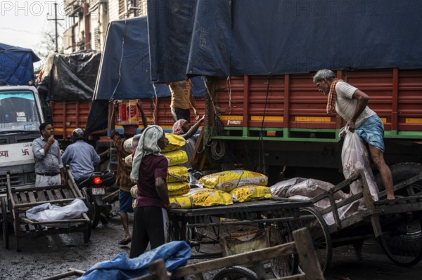 GUWAHATI, INDIA - MAY 1: Labourers carries goods in a wholesale market, in Guwahati, India, on May