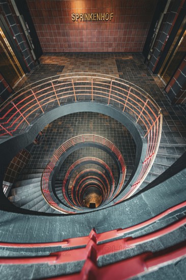 Vertical view from above through a spiral staircase in a building called Sprinkenhof, Hamburg,