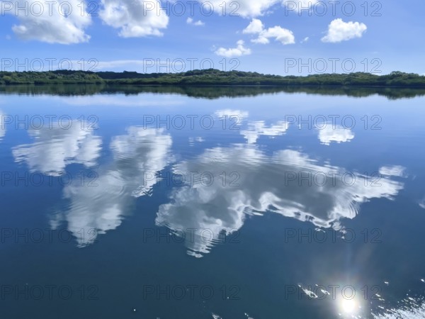 Reflection of white clouds cumulus in lagoon of Yap Island in Pacific Ocean, Caroline Islands, Yap