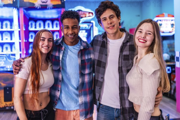 Four young multiethnic friends are smiling and having fun at an arcade, enjoying various games and