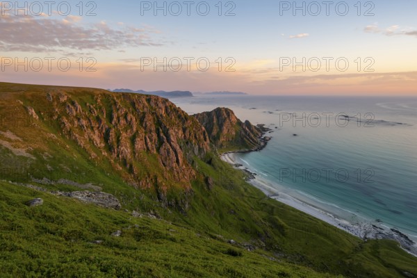 View of coastal landscape at sunset, cliffs, Høyvika beach and sea, hike to the summit of Måtind or