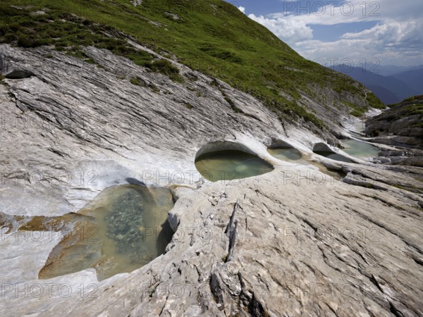 Glacier mill with glacier pots on the Trinser Alp Mora, Trin, Canton Graubünden, Switzerland,