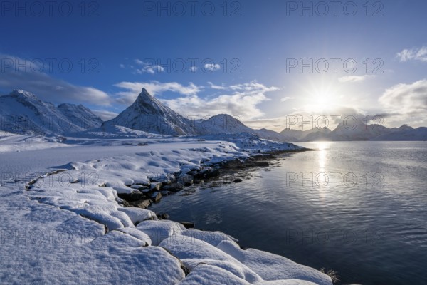 Snowy landscape with mountains and fjord, Volandstinden mountain, Fredvang, Flakstadøya, Lofoten,
