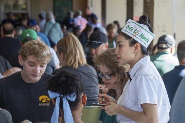 New Orleans, Louisiana - A server takes orders at Cafe du Monde. The coffee shop in the French