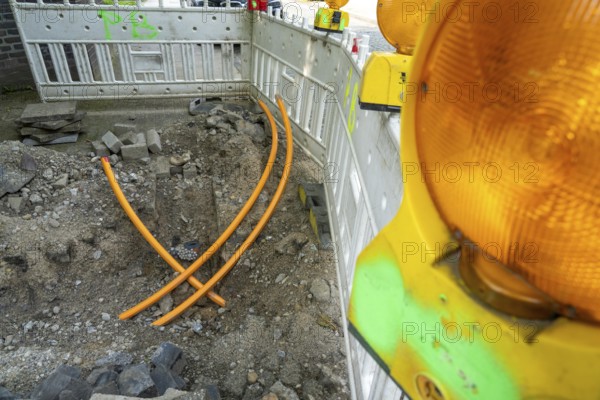 Laying of fibre optic cables, empty conduits are laid under a pavement, in which the actual fibre