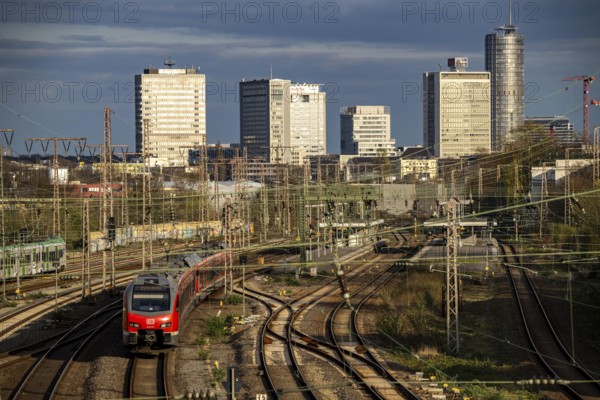 Train on the tracks west of Essen central station, city centre skyline, regional express train,