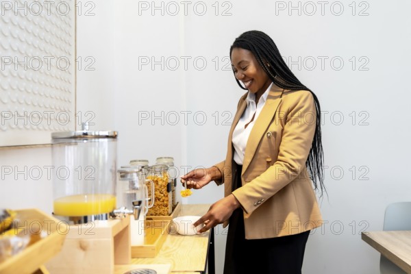 Smiling businesswoman serving breakfast from hotel buffet during business trip, enjoying orange
