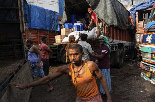 GUWAHATI, INDIA - MAY 1: Labourers carries goods in a wholesale market, in Guwahati, India, on May