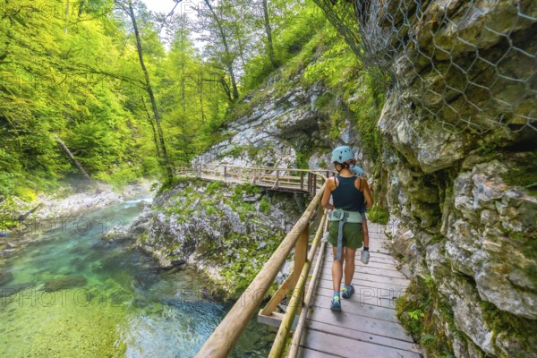 Mother and child enjoying a hike through the scenic vintgar gorge near bled, slovenia, walking