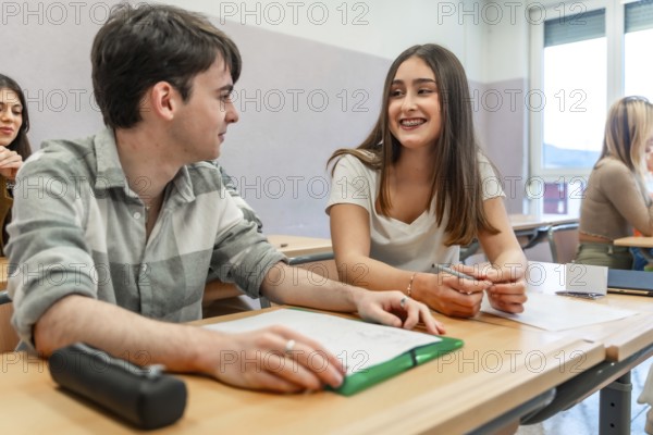 Two university students are working together on a project, sharing ideas and collaborating in a