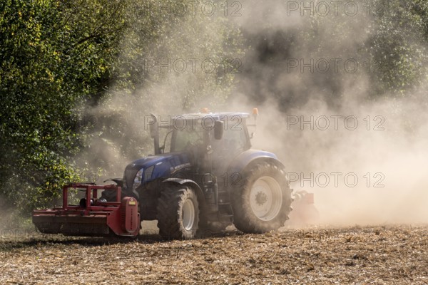 Tractor with plough digging up dried-out soil, large cloud of dust, dust, dry, field, soil,