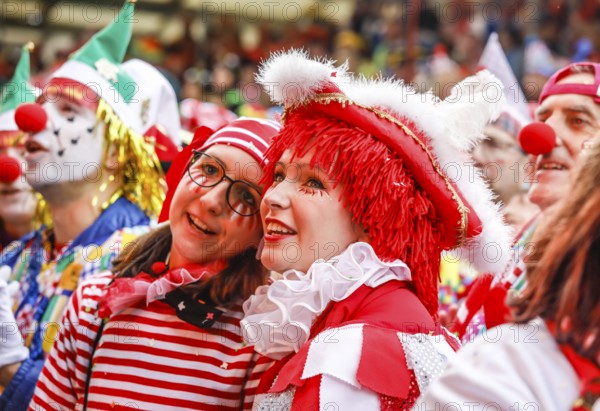Colourfully costumed carnivalists celebrate carnival in Cologne, on Weiberfastnacht the street