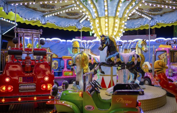 Horses, fire brigade on children's carousel, rides, neon lights, Cannstatter Wasen, funfair, spring