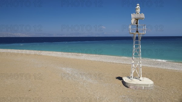Northern tip of Rhodes, isolated lighthouse on sandy beach with wide sea view, harbour area, Rhodes