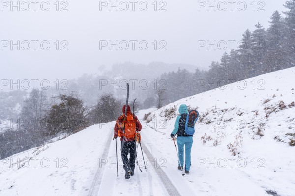 A couple of skiers on Mount Aizkorri in Gipuzkoa. Snowy landscape by winter snows. Basque Country,