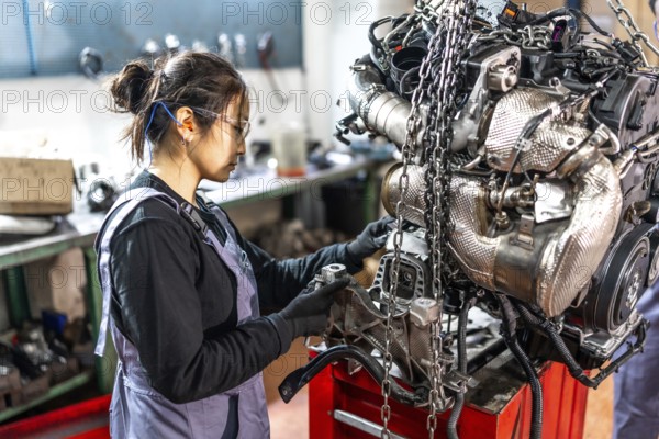 Skilled mechanic assembling engine parts in a professional workshop, showcasing expertise and