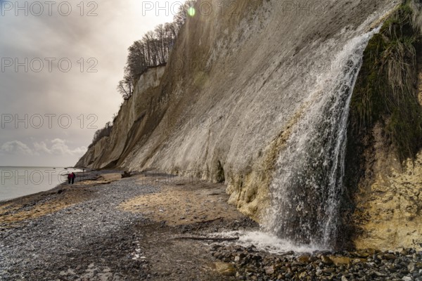 Waterfall of the Kiel stream on the Kiel shore and the famous chalk cliffs on the Baltic Sea coast