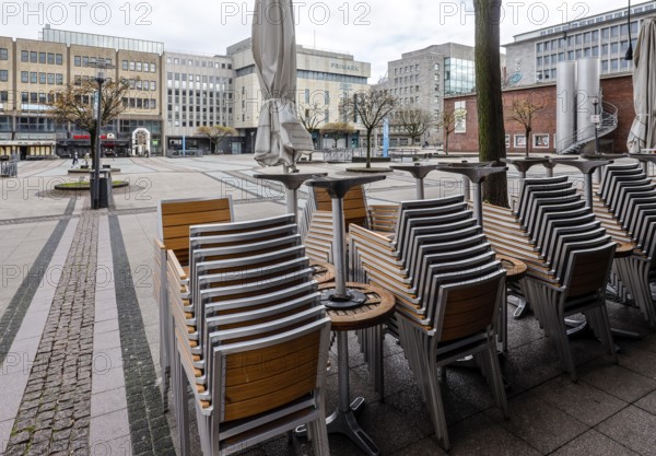 Deserted city centre with closed restaurants and shops due to corona pandemic contact ban,