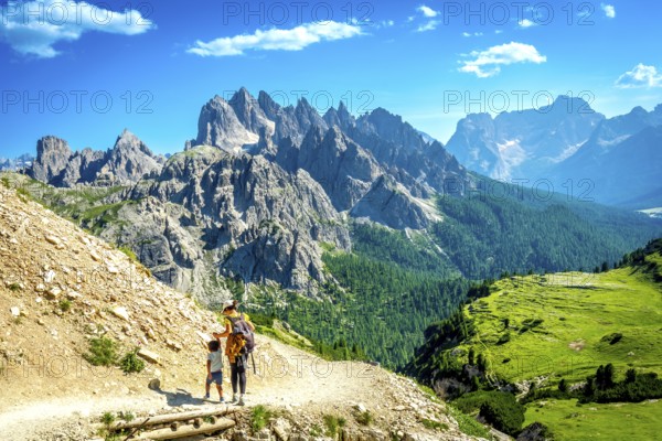 Tourists enjoying breathtaking views while hiking on a scenic trail in tre cime di lavaredo,