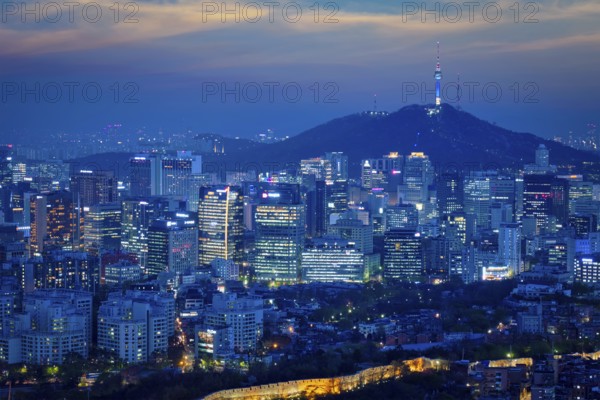 Seoul downtown cityscape illuminated with lights and Namsan Seoul Tower in the evening view from