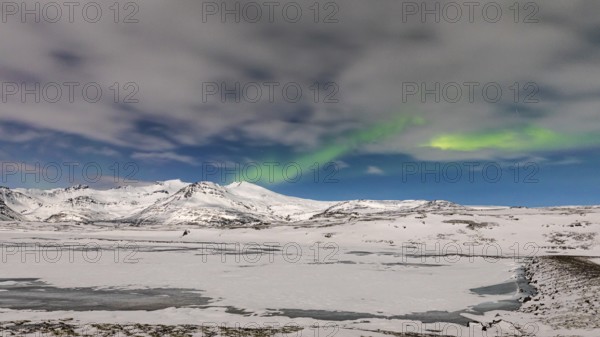 Northern Lights, Aurora Borealis, over snow-covered landscape at Skalafellsjökull, Sudurland,