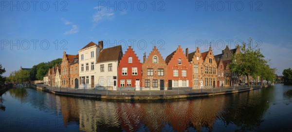 Typical Belgian cityscape Europe tourism concept, panorama of canal and old houses on sunset.