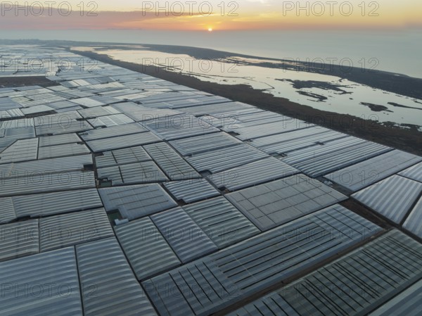 Masses of shimmering plastic greenhouses at the coast of El Ejido aside with the lagoon Salinas de