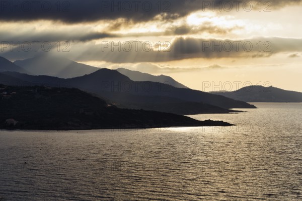 Coastline backlit, sun rays through clouds, L'Île-Rousse, Ile Rousse, Haute-Corse, Balagne, North