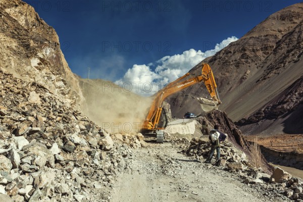 LADAKH, INDIA, SEPTEMBER 10, 2011: Excavator cleaning road after landslide in Himalayas. Ladakh,