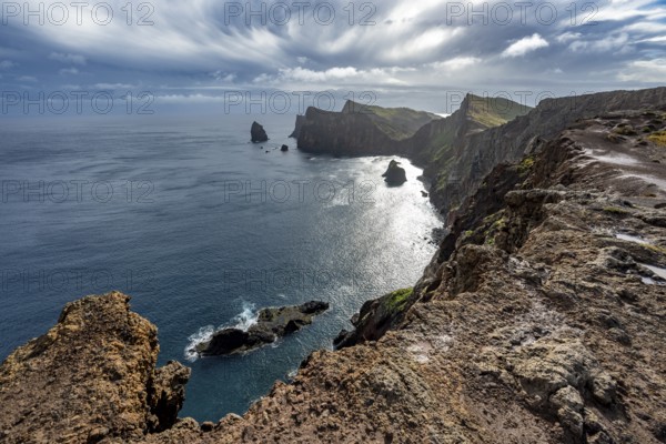 Red cliffs and rocks in the sea, coastal landscape with dramatic sky, Ponta de São Lourenço,