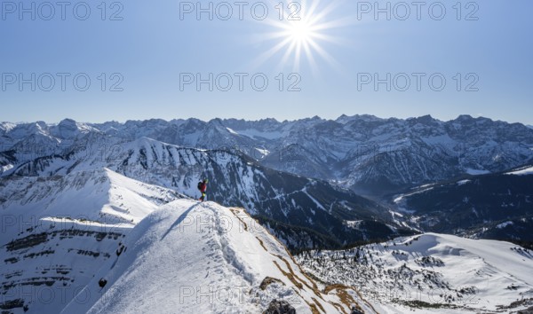 Ski tourers at the summit of Schafreuter, view of snowy mountain panorama, Sonnenstern, Karwendel,