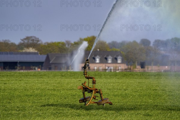 Artificial irrigation of a cereal field in April, with a sprinkler system, long dry spell in spring