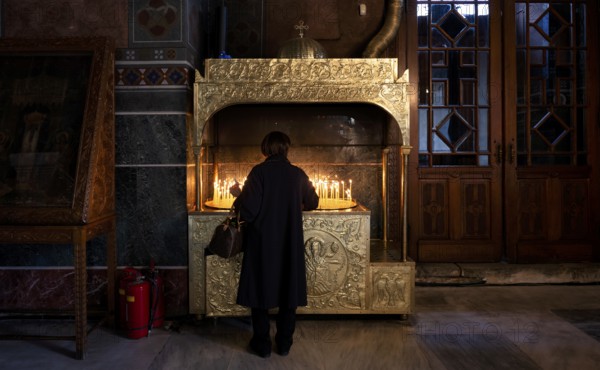 Woman offering a candle, from behind, interior view of Hagia Sofia church, also Agia Sofia, dome,