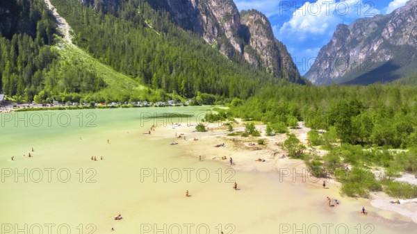 Tourists enjoying summer at lago di landro, also known as durrensee lake, surrounded by the