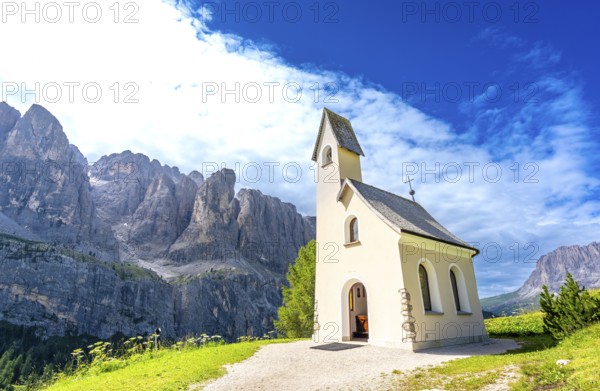 Scenic view of a charming church nestled in the italian dolomites, with the breathtaking peaks
